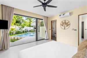 a bedroom with a bed and a view of a pool at Samudo 3br Tropical Haven in Bophut +41 photos