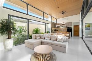 a living room with a white couch and a table at Samudo 3br Tropical Haven in Bophut
