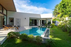 a swimming pool in the backyard of a house at Samudo 3br Tropical Haven in Bophut