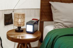 a bedroom with a bed and a night stand with a television at Creekside Retreat at Triangle Lake in Blachly