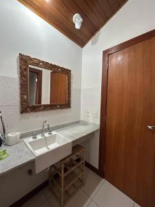 a bathroom with a sink and a mirror at Apartamento Exclusivo Búzios Centro in Búzios +73 photos