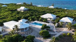 an aerial view of the resort and the ocean at Kalopsia Seaside Villas & Marina in Great Guana Cay