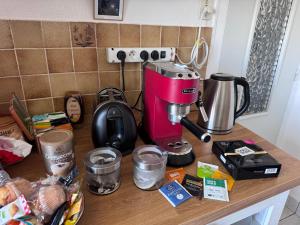 a counter with a pink mixer on a table at Villa Auguste chambres d'hôtes in Quimper