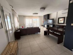 a living room with a couch and a table at Fotis Resort in Iraklitsa