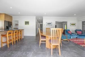 a kitchen and dining room with a table and chairs at All Inn in Rotorua +21 photos