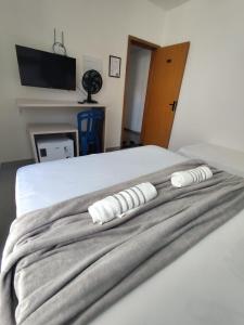 a bedroom with a bed with two pillows on it at Suíte 14 Família in Pontal do Paraná