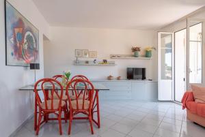a living room with a table and two chairs at Beaulieu Garden Apartment in Beaulieu-sur-Mer +9 photos