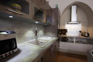 a kitchen with a sink and a stove at Le Royere in Sarlat-la-Canéda +24 photos