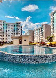a large swimming pool in front of some buildings at MD Suite by Seawind in Davao City