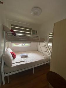 a bunk bed in a small room with a window at MD Suite by Seawind in Davao City
