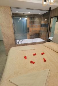 a bedroom with a bed with red rose petals on it at Pavlovic Luxury Spa in Vrnjačka Banja +27 photos