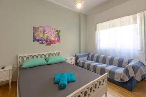 a bedroom with a bed and a couch at Athens center traditional & classic 2BR apartment in Mesochórion
