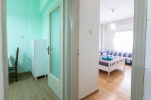 a hallway with a room with a bed and a door at Athens center traditional & classic 2BR apartment in Mesochórion