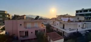 an aerial view of buildings with the sunset in the background at Villa Margot in Ksamil +1 photo