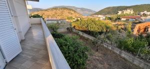 a balcony of a house with a view of a mountain at Villa Margot in Ksamil