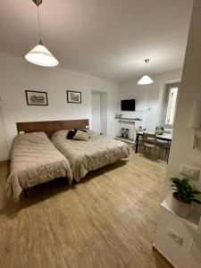 a bedroom with a bed and a living room at Dimora del Teatro in Spoleto