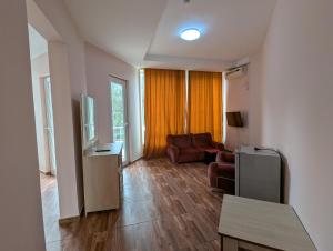 a living room with a couch and a table at Panorama hotel kobuleti in Kobuleti