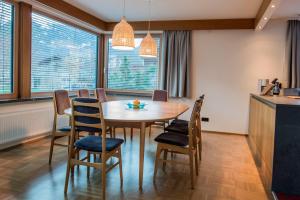a kitchen and dining room with a wooden table and chairs at Chalet Montafon Schruns in Schruns