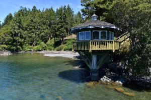 a tree house in the middle of a river at Pacific Coast Beach House by EMR Vacation Rentals in Sooke