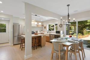 a kitchen and dining room with a table and chairs at The Bayside Cottage by EMR Vacation Rentals in North Saanich