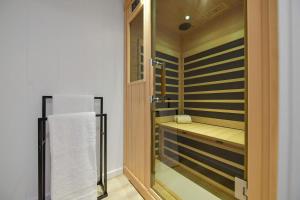 a bathroom with a shower with a bench and a towel at The Bayside Cottage by EMR Vacation Rentals in North Saanich