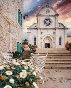 a church with a table and chairs in front of it at Room Jakov in Šibenik