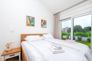 a white bedroom with a large bed and a window at Echo villa, Istra, pool/jacuzzi, BBQ, pet friendly in Šegotići +47 photos