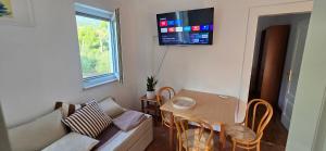 a small living room with a table and a couch at Apartments Villa Andreja in Starigrad
