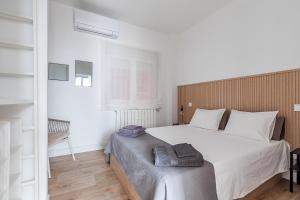 a bedroom with a large white bed and a window at AB40 Home Design in Madrid