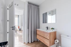 a white bathroom with a sink and a mirror at AB40 Home Design in Madrid