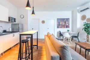 a kitchen and a living room with a couch and a table at AB40 Home Design in Madrid +12 photos