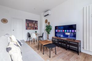 a living room with a couch and a flat screen tv at AB40 Home Design in Madrid