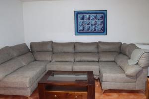 a living room with a couch and a coffee table at El cortijo azul in Güéjar-Sierra