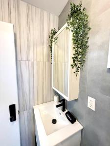 a bathroom with a sink and a mirror at Madison Ave Oasis in New York
