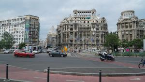a busy city street with cars and buildings at Bucarest old center in Văleni +13 photos