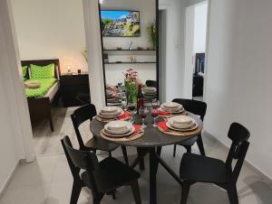a dining room with a table and chairs in a living room at Bucarest old center in Văleni