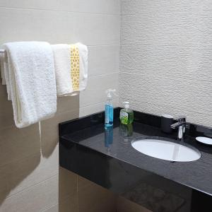 a bathroom with a sink and a mirror and towels at Diana Ennour in Rabat +16 photos