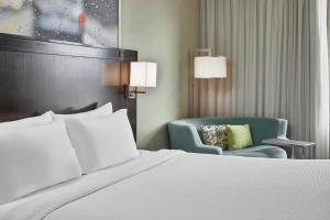 a bed and a chair in a hotel room at Courtyard by Marriott Portland City Center in Portland +51 photos