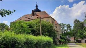 an old building with a domed roof in a yard at Schloss Ruhethal in Mügeln