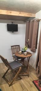a wooden table and a chair and a table and a television at Villa - Malibu' B & B in Lauria +42 photos