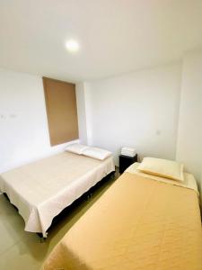 a room with two beds in a room at Santa Isabel Centro 302 in Santa Rosa de Cabal