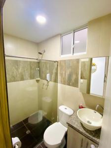a bathroom with a toilet and a sink and a shower at Santa Isabel Centro 302 in Santa Rosa de Cabal +9 photos