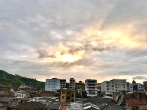 a group of buildings in a city under a cloudy sky at Santa Isabel Centro 302 in Santa Rosa de Cabal