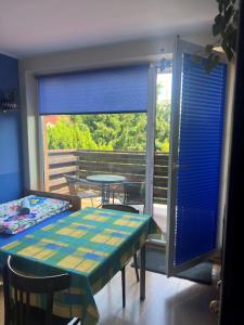 a room with a table and a view of a balcony at Agroturystyka Willa Ola in Giewartów +25 photos