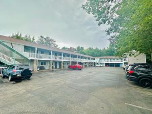 a parking lot in front of a large building at Hampton Motor Inn in Hampton