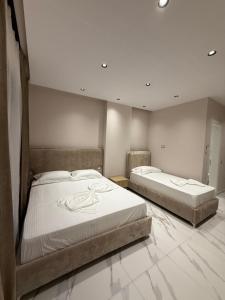 two twin beds in a room with at Azure Waves in Vlorë