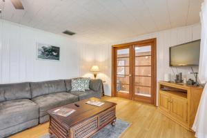 a living room with a couch and a tv at Boat Lift and Private Dock Riverfront LaBelle Gem in La Belle
