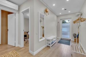 a living room with white walls and wooden floors at The Flower Nest in Zvejniekciems +34 photos