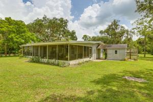 a house with a large yard in front of it at Boat Lift and Private Dock Riverfront LaBelle Gem in La Belle