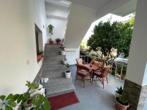 a patio with stairs and a table and chairs at Klarisa Beach Apartment in Golem
